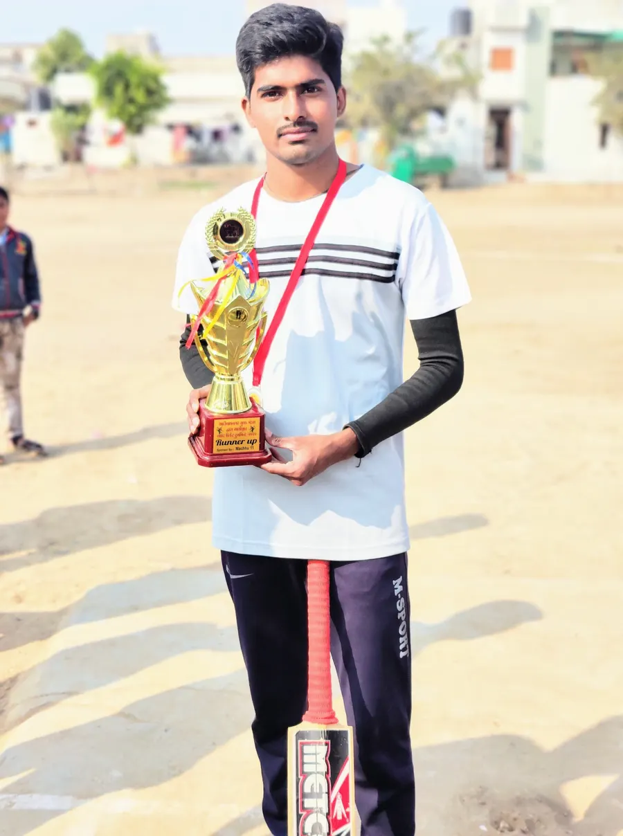 Divyesh with his cricket bat at a local ground